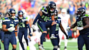 Nov 9, 2025; Seattle, Washington, USA; Seattle Seahawks linebacker Drake Thomas (42) celebrates a defensive stop during the first quarter against the Arizona Cardinals at Lumen Field.