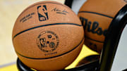 The NBA logo is seen on a basketball.