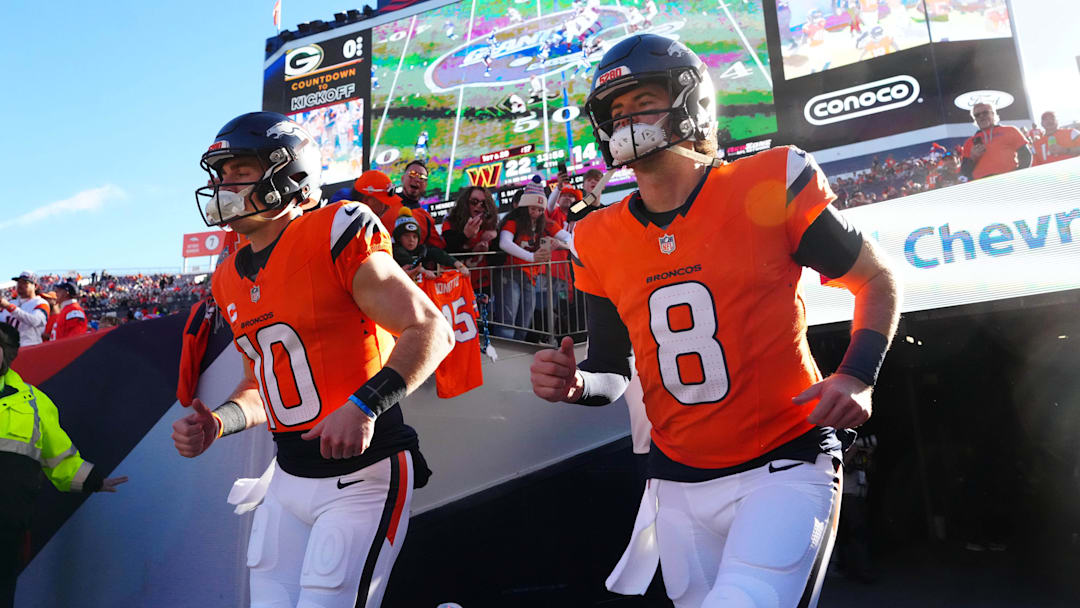 Dec 14, 2025; Denver, Colorado, USA; Denver Broncos quarterback Bo Nix (10) and quarterback Jarrett Stidham (8) run out for player introductions prior to a game against the Green Bay Packers at Empower Field at Mile High. 
