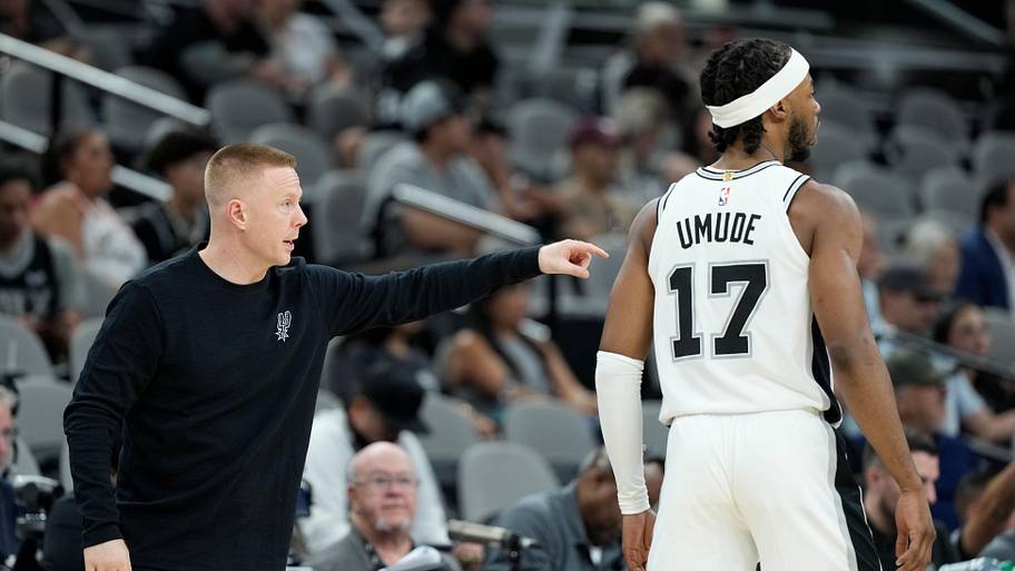 San Antonio Spurs assistant head coach Sean Sweeney talks with guard Stanley Umude.