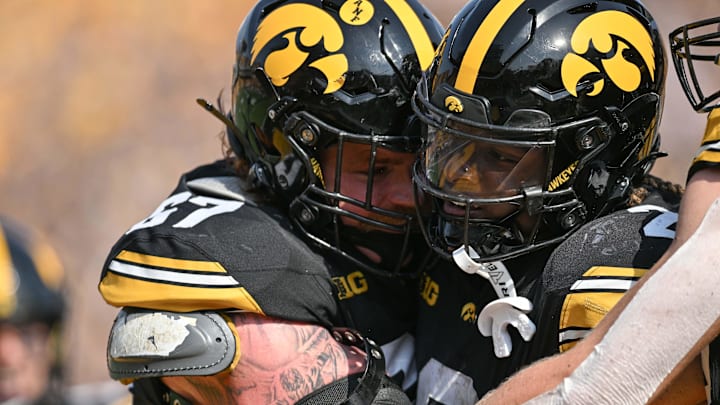 Oct 12, 2024; Iowa City, Iowa, USA; Iowa Hawkeyes running back Kaleb Johnson (2) reacts with offensive lineman Gennings Dunker (67) after his third touchdown run during the fourth quarter against the Washington Huskies at Kinnick Stadium. Mandatory Credit: Jeffrey Becker-Imagn Images