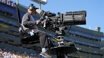 Oct 20, 2024; Green Bay, Wisconsin, USA;  General view of a television camera operator during the game between the Houston Texans and Green Bay Packers at Lambeau Field. Mandatory Credit: Jeff Hanisch-Imagn Images