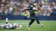 Aug 7, 2025; Seattle, Washington, USA; Seattle Seahawks running back George Holani (36) breaks a tackle by Las Vegas Raiders cornerback Darien Porter (26) during the first half at Lumen Field.