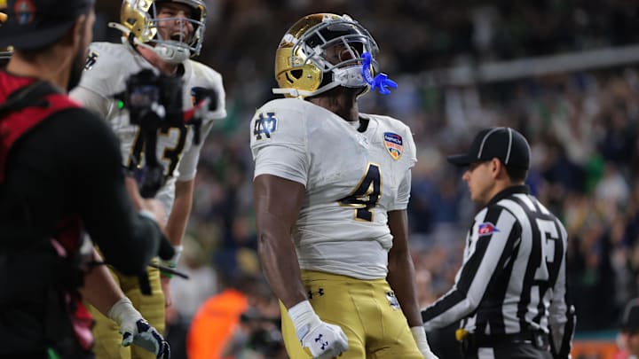 Jan 9, 2025; Miami, FL, USA; Notre Dame Fighting Irish running back Jeremiyah Love (4) celebrates a touch down in the second half against the Penn State Nittany Lions in the Orange Bowl at Hard Rock Stadium. Mandatory Credit: Sam Navarro-Imagn Images