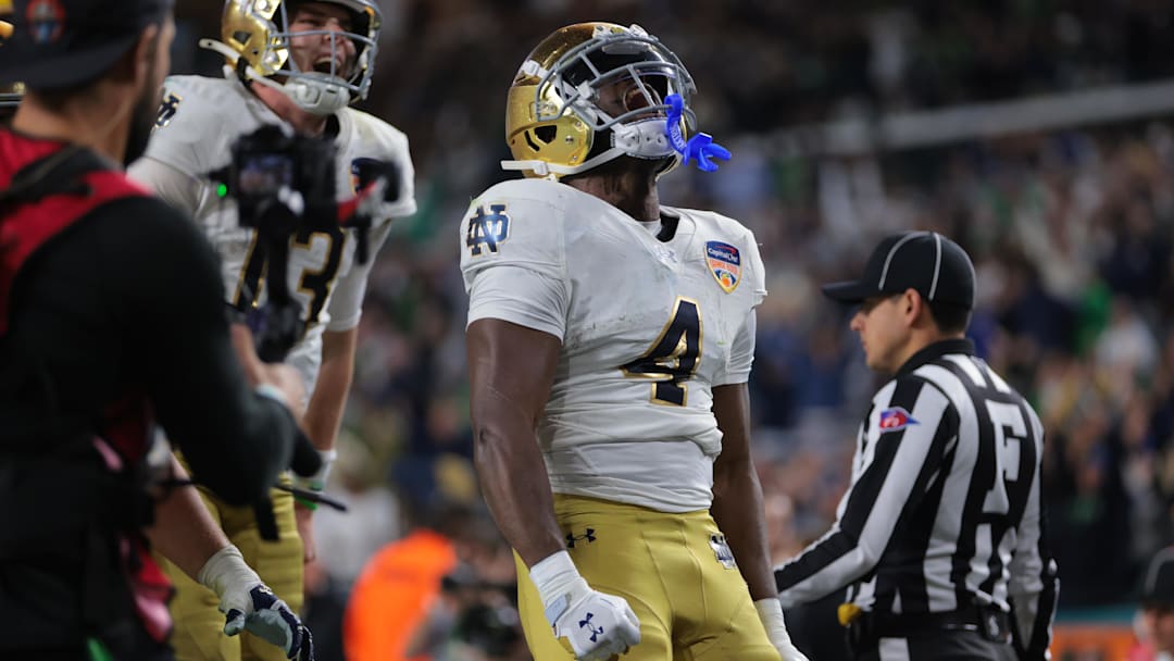 Jan 9, 2025; Miami, FL, USA; Notre Dame Fighting Irish running back Jeremiyah Love (4) celebrates a touch down in the second half against the Penn State Nittany Lions in the Orange Bowl at Hard Rock Stadium. Mandatory Credit: Sam Navarro-Imagn Images