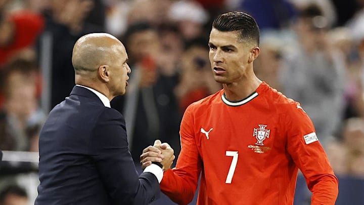 The decision over Cristiano Ronaldo's (right) international career is a huge call for Portugal manager Roberto Martínez