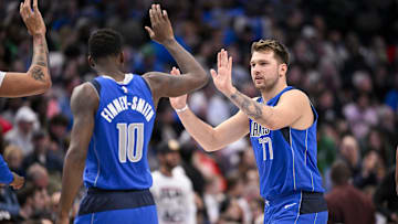 Nov 18, 2022; Dallas, Texas, USA; Dallas Mavericks forward Dorian Finney-Smith (10) and guard Luka Doncic (77) in action during the game between the Dallas Mavericks and the Denver Nuggets at the American Airlines Center. Mandatory Credit: Jerome Miron-Imagn Images