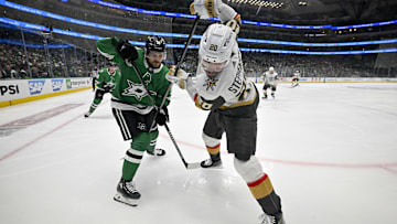 May 5, 2024; Dallas, Texas, USA; Dallas Stars center Sam Steel (18) and Vegas Golden Knights center Chandler Stephenson (20) battle for control of the puck during the first period in game seven of the first round of the 2024 Stanley Cup Playoffs at American Airlines Center. Mandatory Credit: Jerome Miron-Imagn Images