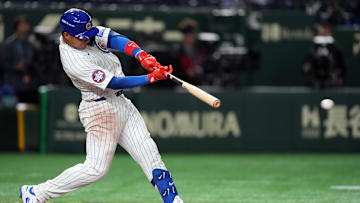Mar 15, 2025; Bunkyo, Tokyo, Japan; Chicago Cubs catcher Miguel Amaya (9) hits a single against the Hanshin Tigers during the sixth inning at Tokyo Dome. Mandatory Credit: Darren Yamashita-Imagn Images