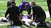 Aug 9, 2025; Minneapolis, Minnesota, USA; Minnesota Vikings wide receiver Rondale Moore (4) is attended to by head coach Kevin O'Connell and trainers after suffering a lower leg injury during the second quarter against the Houston Texans at U.S. Bank Stadium.