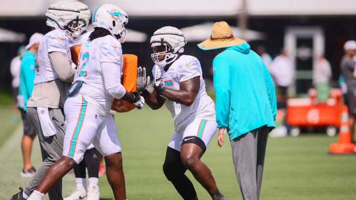 Jul 29, 2024; Miami Gardens, FL, USA; Miami Dolphins guard Robert Jones (65) works out with offensive tackle Patrick Paul (52) during training camp at Baptist Health Training Complex.