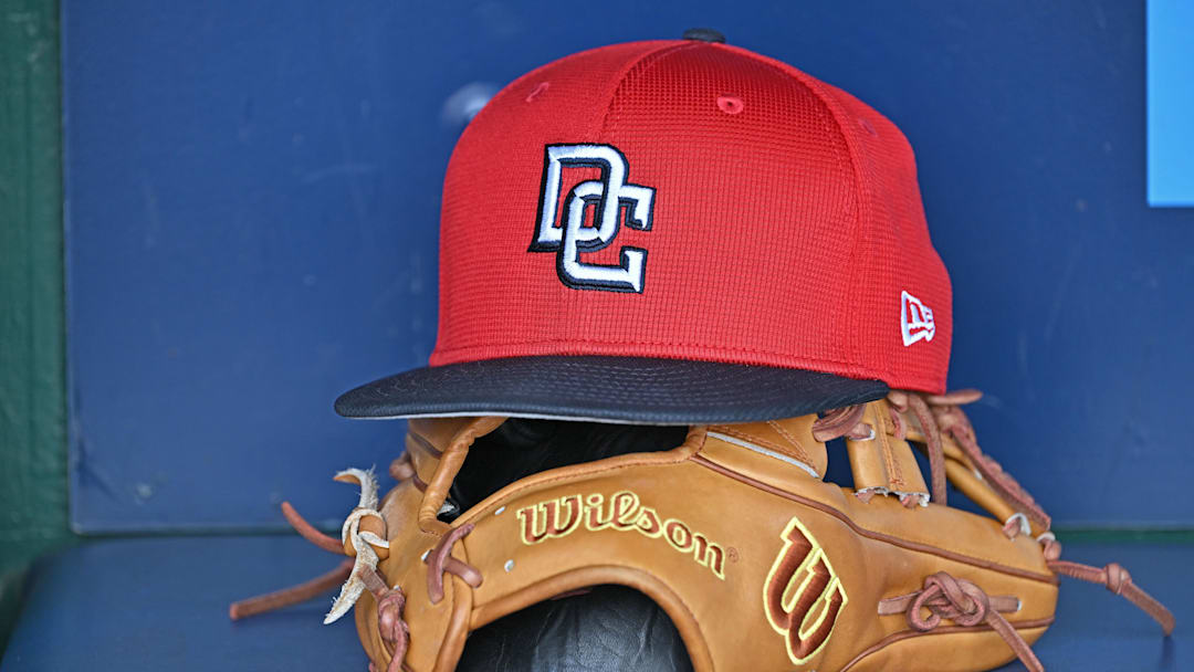 Aug 12, 2025; Kansas City, Missouri, USA;  A Washington Nationals hat and glove in the dugout before a game against the Kansas City Royals at Kauffman Stadium. Mandatory Credit: Peter Aiken-Imagn Images