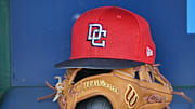 Aug 12, 2025; Kansas City, Missouri, USA;  A Washington Nationals hat and glove in the dugout before a game against the Kansas City Royals at Kauffman Stadium. 