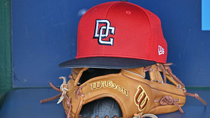 A Washington Nationals hat and glove in the dugout before a game against the Royals at Kauffman Stadium. 