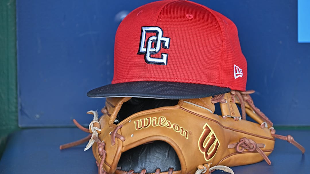 A Washington Nationals hat and glove in the dugout before a game against the Kansas City Royals at Kauffman Stadium. A Washington Nationals hat and glove in the dugout before a game against the Kansas City Royals at Kauffman Stadium.