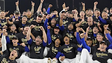 Oct 11, 2024; Los Angeles, California, USA; Los Angeles Dodgers players and coaches celebrate on the field after defeating the San Diego Padres in game five of the NLDS for the 2024 MLB Playoffs at Dodger Stadium. Mandatory Credit: Jayne Kamin-Oncea-Imagn Images