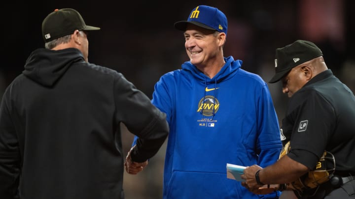 Seattle Mariners manager Dan Wilson (center) shares a greeting before a game against the San Francisco Giants on Friday at T-Mobile Park.