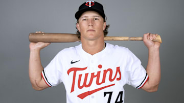 Twins prospect Luke Keaschall shows off the Tommy John surgery scar on his right elbow as he poses for a picture with his bat during Spring Training 2005.  