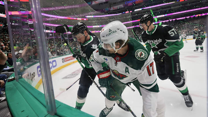 Apr 18, 2026; Dallas, Texas, USA; Dallas Stars defenseman Thomas Harley (55)and Minnesota Wild left wing Marcus Foligno (17) battle for the puck in the corner in the first period in game one of the first round of the 2026 Stanley Cup Playoffs at American Airlines Center. Mandatory Credit: Thomas Shea-Imagn Images