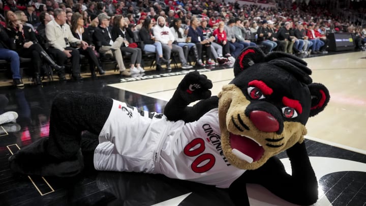 Dec 29, 2023; Cincinnati, Ohio, USA;  The Bearcat mascot lies on the court during the game between the Evansville Aces and the Cincinnati Bearcats in the second half at Fifth Third Arena. Mandatory Credit: Aaron Doster-USA TODAY Sports