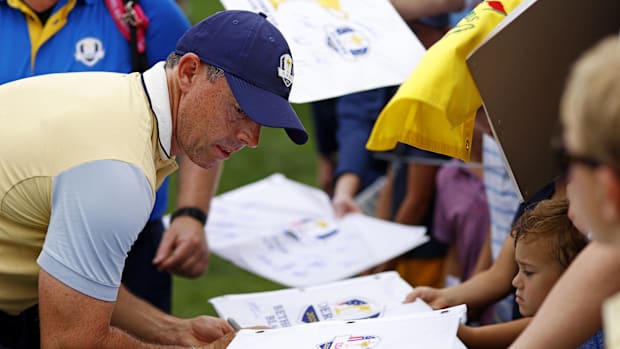 Rory McIlroy signs autographs during a practice round of the Ryder Cup