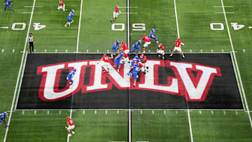 A general overall view as UNLV Rebels quarterback Jayden Maiava (1) throws the ball on the UNLV logo at midfield against the Boise State Broncos in the first half during the Mountain West Championship at Allegiant Stadium. Mandatory Credit: Kirby Lee-Imagn Images
