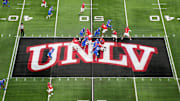 A general overall view as UNLV Rebels quarterback Jayden Maiava (1) throws the ball on the UNLV logo at midfield against the Boise State Broncos in the first half during the Mountain West Championship at Allegiant Stadium. Mandatory Credit: Kirby Lee-Imagn Images