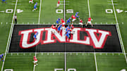 A general overall view as UNLV Rebels quarterback Jayden Maiava (1) throws the ball on the UNLV logo at midfield against the Boise State Broncos in the first half during the Mountain West Championship at Allegiant Stadium. Mandatory Credit: Kirby Lee-Imagn Images