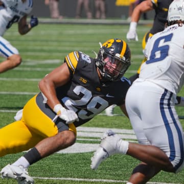 Iowa Hawkeyes defensive back Sebastian Castro (29) tries to tackle Devon Booth of Utah State as the Hawkeyes take on Utah State at Kinnick Stadium in Iowa City, Saturday, Sept. 2, 2023.