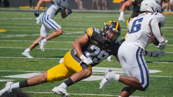 Iowa Hawkeyes defensive back Sebastian Castro (29) tries to tackle Devon Booth of Utah State as the Hawkeyes take on Utah State at Kinnick Stadium in Iowa City, Saturday, Sept. 2, 2023.