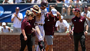Jun 8, 2024; College Station, TX, USA; Texas A&M outfielder Braden Montgomery (6) is helped off the field by the medical team after a brace is placed on his right leg during the game against Oregon at Olsen Field, Blue Bell Park Mandatory Credit: Maria Lysaker-USA TODAY Sports