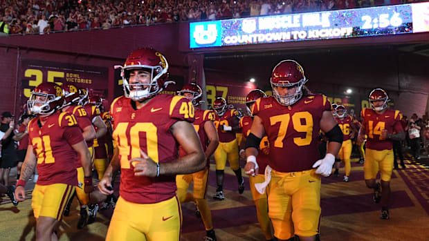 The USC Trojans run out of the tunnel before the game against the Utah State Aggies 