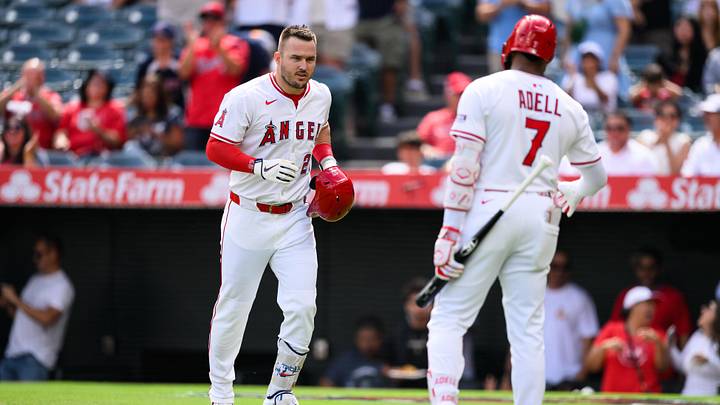 Sep 28, 2025; Anaheim, California, USA; Los Angeles Angels designated hitter Mike Trout (27), left, is greeted by right fielder Jo Adell (7) after hitting a home run during the first inning against the Houston Astros at Angel Stadium. Mandatory Credit: William Liang-Imagn Images