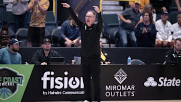 Dec 1, 2024; Estero, FL, USA; West Virginia University head coach Mark Kellogg calls a play in the from the sidelines in the fourth quarter during the Women's Gulf Coast Showcase at Hertz Arena. Mandatory Credit: Chris Tilley-Imagn Images