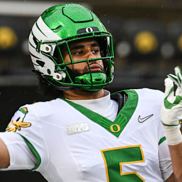 Nov 8, 2025; Iowa City, Iowa, USA; Oregon Ducks quarterback Dante Moore (5) warms up before the game against the Iowa Hawkeyes at Kinnick Stadium. Mandatory Credit: Jeffrey Becker-Imagn Images