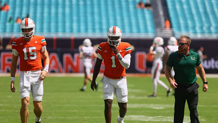 Sep 14, 2024; Miami Gardens, Florida, USA; Miami Hurricanes quarterback Judd Anderson (15) and quarterback Cam Ward (1) works out before the game against the Ball State Cardinals at Hard Rock Stadium. Mandatory Credit: Sam Navarro-Imagn Images