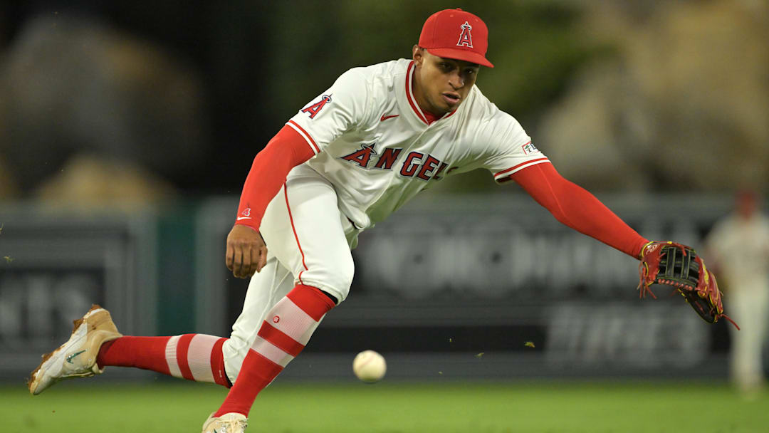 Sep 23, 2025; Anaheim, California, USA;  Kansas City Royals second baseman Adam Frazier (26) singles past Los Angeles Angels second baseman Christian Moore (4) during the fourth inning at Angel Stadium. Mandatory Credit: Jayne Kamin-Oncea-Imagn Images