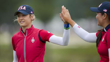 Korda and Allisen Corpuz of Team USA high-five during foursomes matches against Team Europe at the Solheim Cup.