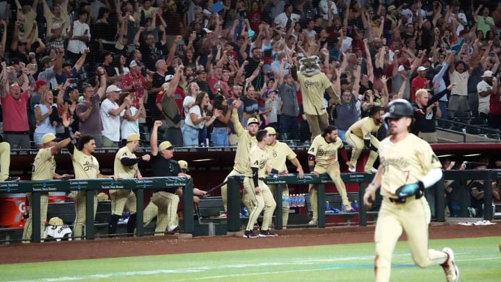 Aug 13, 2024; Phoenix, Arizona, USA; Arizona Diamondbacks fans and players celebrate as Arizona Diamondbacks outfielder Corbin Carroll (7) scores a run during a walk off two RBI single by Arizona Diamondbacks outfielder Jake McCarthy (not pictured) during the ninth inning against the Colorado Rockies at Chase Field.