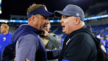 Oct 26, 2024; Lexington, Kentucky, USA; Auburn Tigers head coach Hugh Freeze talks with Kentucky Wildcats head coach Mark Stoops after the game at Kroger Field. Mandatory Credit: Jordan Prather-Imagn Images