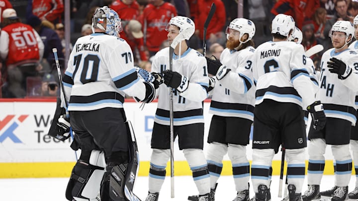Feb 9, 2025; Washington, District of Columbia, USA; Utah Hockey Club goaltender Karel Vejmelka (70) celebrates with teammates after defeating the Washington Capitals during the third period at Capital One Arena. Mandatory Credit: Amber Searls-Imagn Images