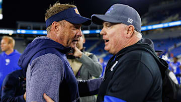 Oct 26, 2024; Lexington, Kentucky, USA; Auburn Tigers head coach Hugh Freeze talks with Kentucky Wildcats head coach Mark Stoops after the game at Kroger Field. Mandatory Credit: Jordan Prather-Imagn Images