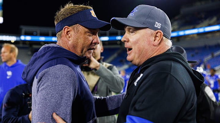 Oct 26, 2024; Lexington, Kentucky, USA; Auburn Tigers head coach Hugh Freeze talks with Kentucky Wildcats head coach Mark Stoops after the game at Kroger Field. Mandatory Credit: Jordan Prather-Imagn Images