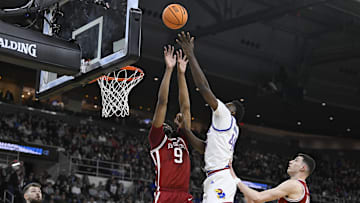 Mar 20, 2025; Providence, RI, USA;  Kansas Jayhawks forward Flory Bidunga (40) shoots the ball defended by Arkansas Razorbacks forward Jonas Aidoo (9) during the first half at Amica Mutual Pavilion. Mandatory Credit: Eric Canha-Imagn Images