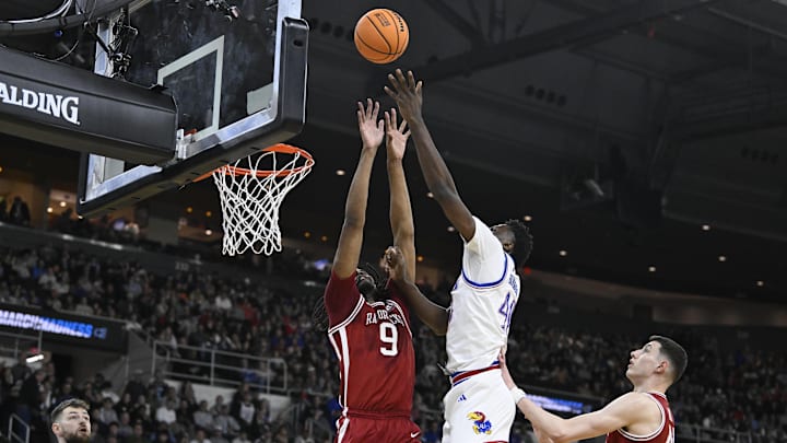 Mar 20, 2025; Providence, RI, USA;  Kansas Jayhawks forward Flory Bidunga (40) shoots the ball defended by Arkansas Razorbacks forward Jonas Aidoo (9) during the first half at Amica Mutual Pavilion. Mandatory Credit: Eric Canha-Imagn Images