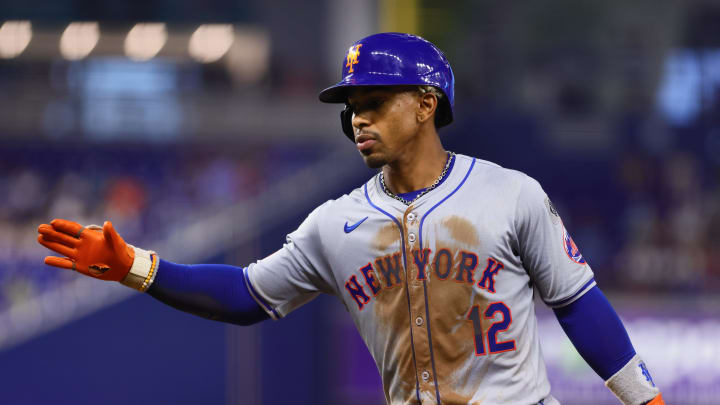 Jul 19, 2024; Miami, Florida, USA; New York Mets shortstop Francisco Lindor (12) reacts from first base after hitting a single against the Miami Marlins during the third inning at loanDepot Park. Mandatory Credit: Sam Navarro-USA TODAY Sports