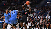 Dec 3, 2024; Villanova, Pennsylvania, USA; Cincinnati Bearcats guard Jizzle James (2) drives to shoot against Villanova Wildcats guard Jordan Longino (15) in the second half at William B. Finneran Pavilion. Mandatory Credit: Kyle Ross-Imagn Images