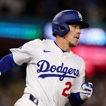 Apr 28, 2025; Los Angeles, California, USA; Los Angeles Dodgers second baseman Tommy Edman (25) runs after hitting a walk off, two-RBI single in the 10th inning against the Miami Marlins at Dodger Stadium. Mandatory Credit: Jason Parkhurst-Imagn Images