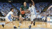 Feb 26, 2024; Chapel Hill, North Carolina, USA; Miami (Fl) Hurricanes guard Kyshawn George (7) with the ball as North Carolina Tar Heels guard Seth Trimble (7) and forward Jalen Washington (13) defend in the first half at Dean E. Smith Center. Mandatory Credit: Bob Donnan-USA TODAY Sports