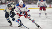 Feb 8, 2025; Columbus, Ohio, USA; New York Rangers right wing Arthur Kaliyev (34) skates with the puck against Columbus Blue Jackets defenseman Jordan Harris (22) in the first period at Nationwide Arena. Mandatory Credit: Aaron Doster-Imagn Images